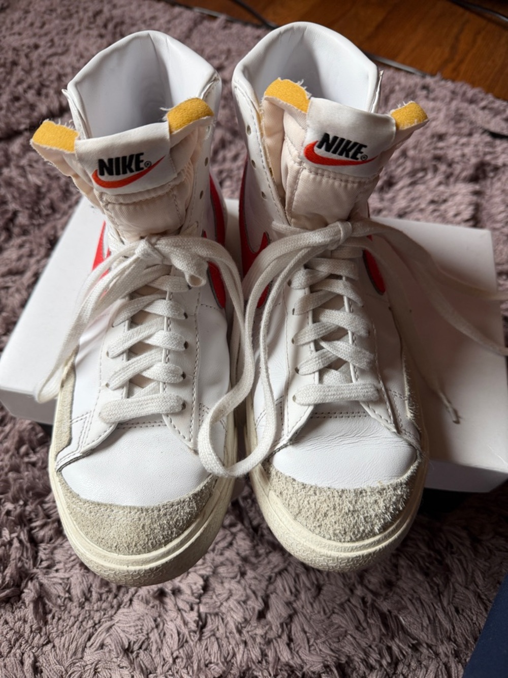 Nike White High-Top Sneakers with Red Swoosh and Yellow Tongue Tabs
